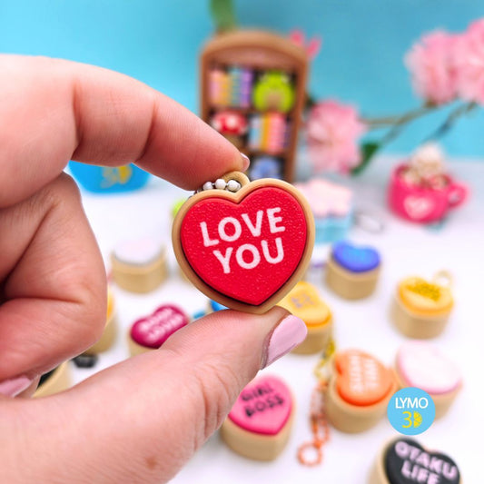 Heart-shaped clicker keychain with text