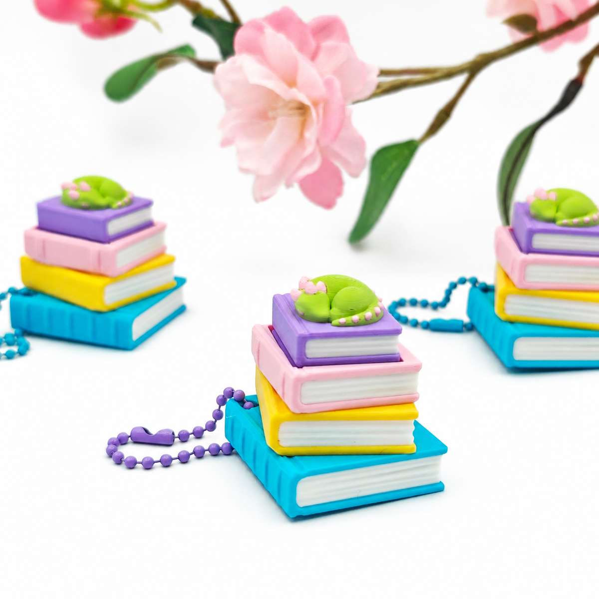 Llavero clicker de libros con dragoncito